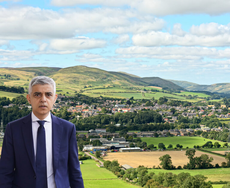 Sadiq Khan with houses and countryside in the back ground
