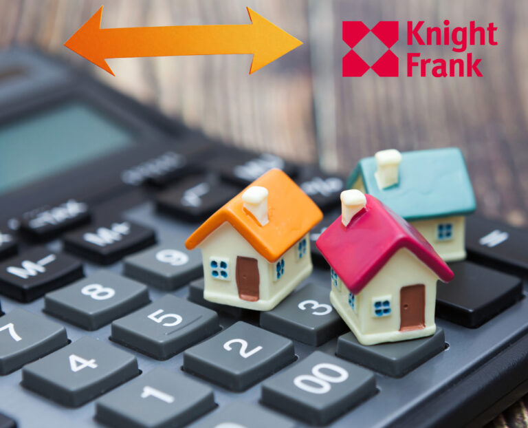 3 small Model houses sitting on a calculator, an arrow pointing right and left