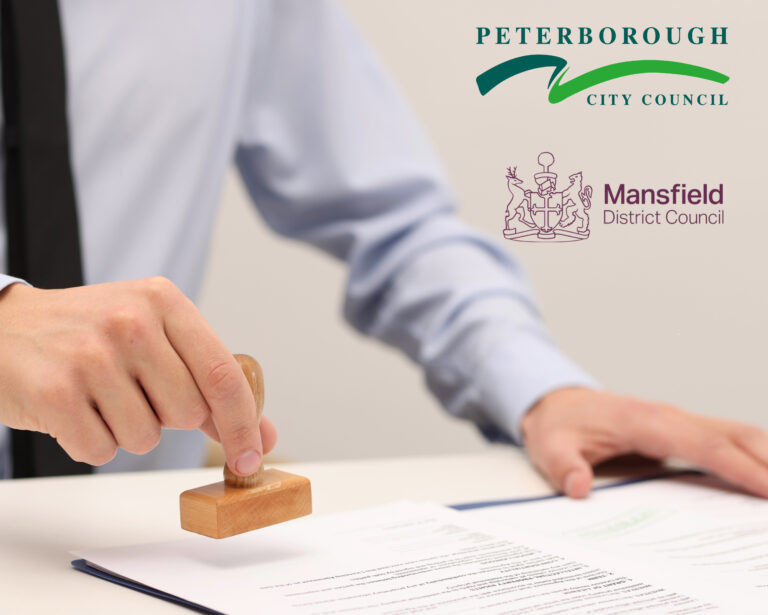 Businessman stamping official papers, Peterborough and Mansfield logos.