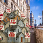 Houses with sold signs with a background of Big Ben, The Thames, and London buildings