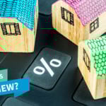 Wooden houses around a percentage sign and text saying What's New