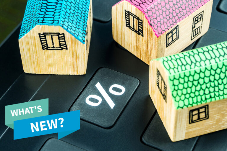 Wooden houses around a percentage sign and text saying What's New