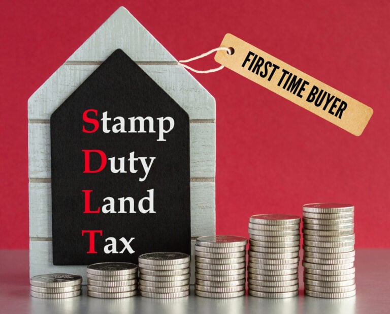 Red background, stacks of coins from small to large, Stamp Duty Land Tax and, First time buyer text