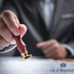 A businessman stamping a form and City of Westminster logo,