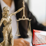 Justice scales, a calender and a businessman in the background