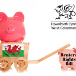 Welsh flag on a wheelbarrow holding a pig and being pulled by a pig saying Renters' Right Bill