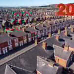 Many streets of houses and a 20% image in red