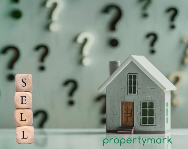 Sell written onto small building blocks next to a model house and questions marks in the background