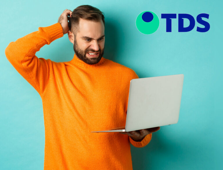 Man scratching his head while holding a laptop with a turquoise background