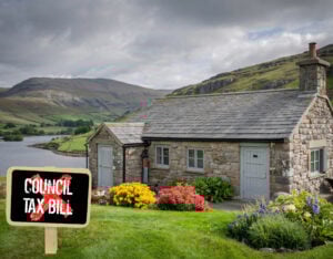 Cottage with backdrop of mountains and lake, and a Council tax bill sign