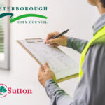Someone checking off items on a clipboard for selective licensing near a house with the peterborough city counil and Sutton council logos