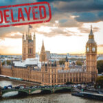 Houses of parliament with a delayed sticker