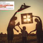 A silhouette family holding a house outline in the sunset with the greater manchester good landlord charter logo