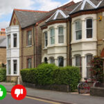 Row of houses that could be HMO flats, with a finger up and down symbol