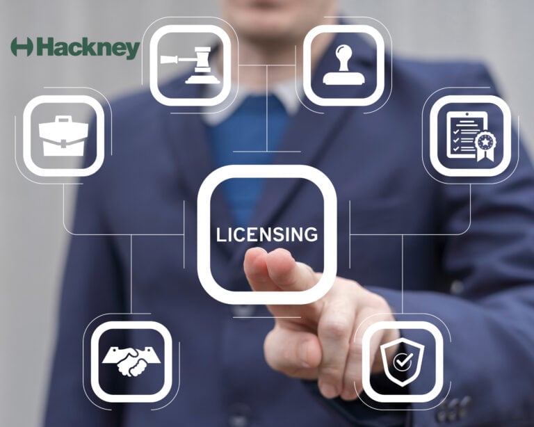 A businessman pressing a button labeled licensing on a digital screen and text saying Hackney