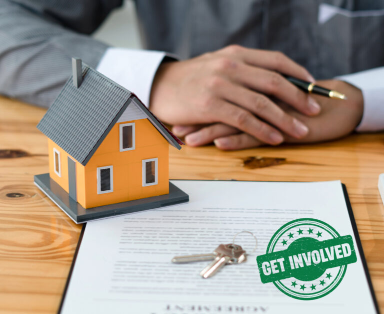 Businessman hands sitting at desk with a house,serco mnortgage form and keys on the table