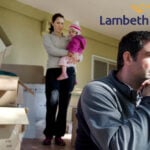 Family looking sad with boxes in a room