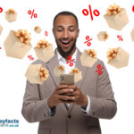 Man with a mobile phone witbh flying presents and percentage signs