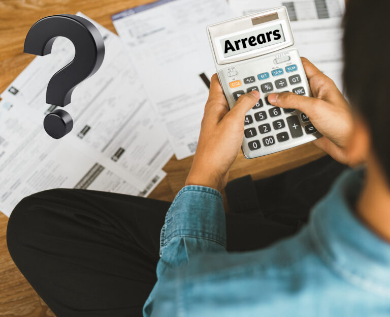 Man on calculater with paperwork and a question mark