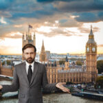 Businessman with hands open with the Houses of Parliament in the background