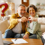 Retired tenenats being handed keys to a house and a question mark