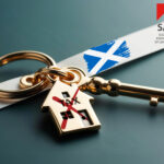 Keyring worded TAX and a redwith key on a white strip with a scottish flag