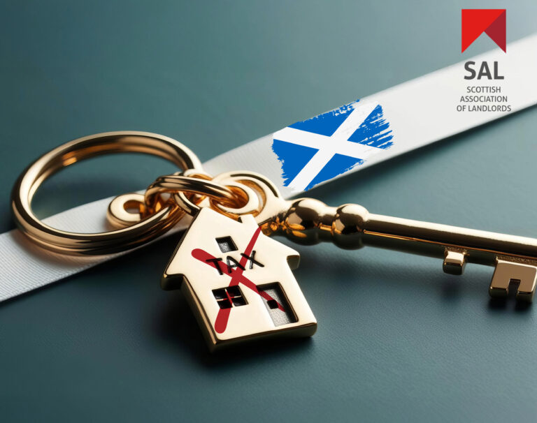 Keyring worded TAX and a redwith key on a white strip with a scottish flag