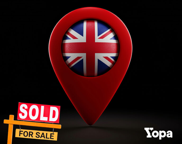 Pin location with the Uk flag inside with a house sold for sale house sign