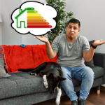 A tenant sitting with his dog on a sofa in a house looking unaware with a thought bubble and an EPC graph