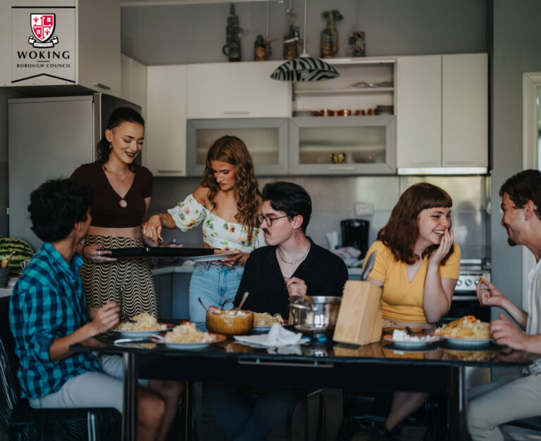 People sharing a kitchen with woking borough council logo