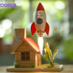 Image of a rocket soaring up above a model house