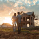 Couple looking at a newly built home at sunset, symbolising growth in build-to-rent housing.