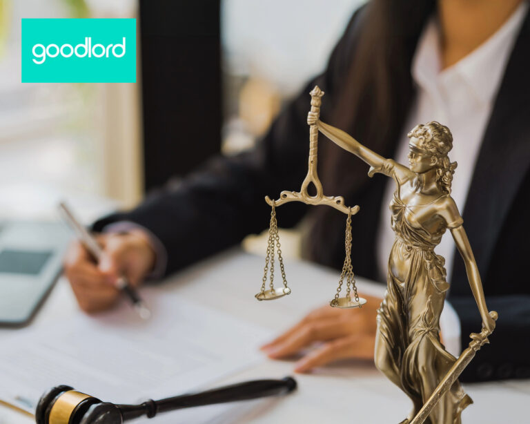 sopmneone sitting at desk signing with the lady of justice