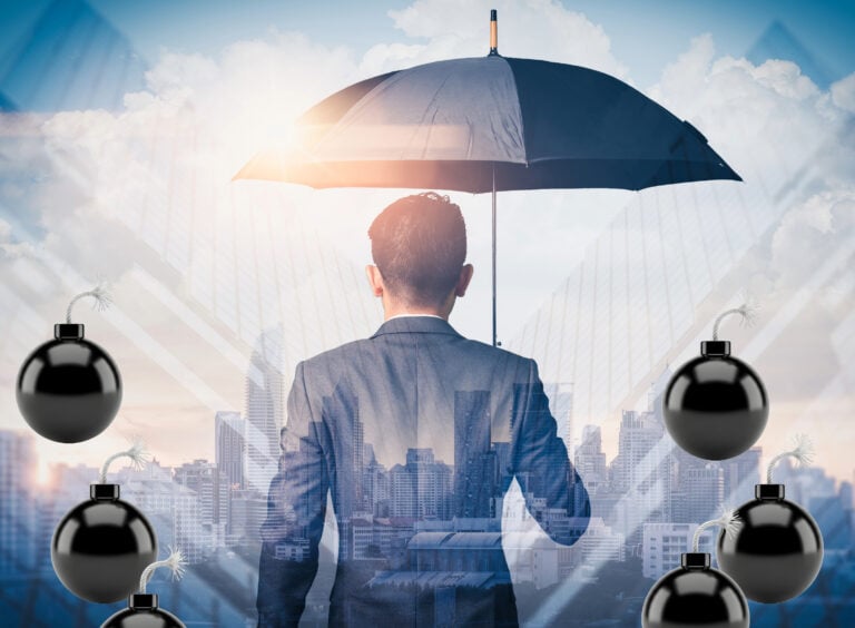 Businessman under umbrella symbolizing landlord protection from financial risks
