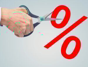 Man cutting a percentage sign