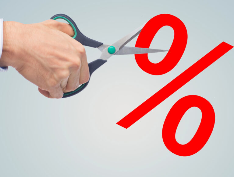 Man cutting a percentage sign