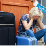 Distressed woman sitting with suitcases outside home, highlighting impact of housing legislation