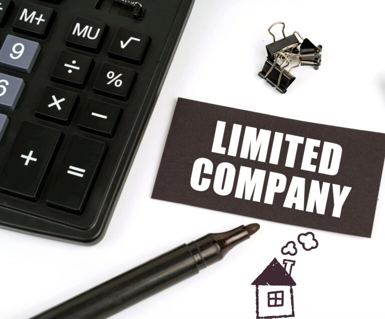 Calculater and pen with a drawing of a house and a limited company label