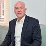 Business professional discussing the financial risks of delaying leasehold reform decisions