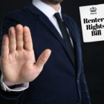 businessman putting hand up to reject the renters Righrs bill document