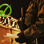 Border patrol torso with high guarded fences and a tick sign