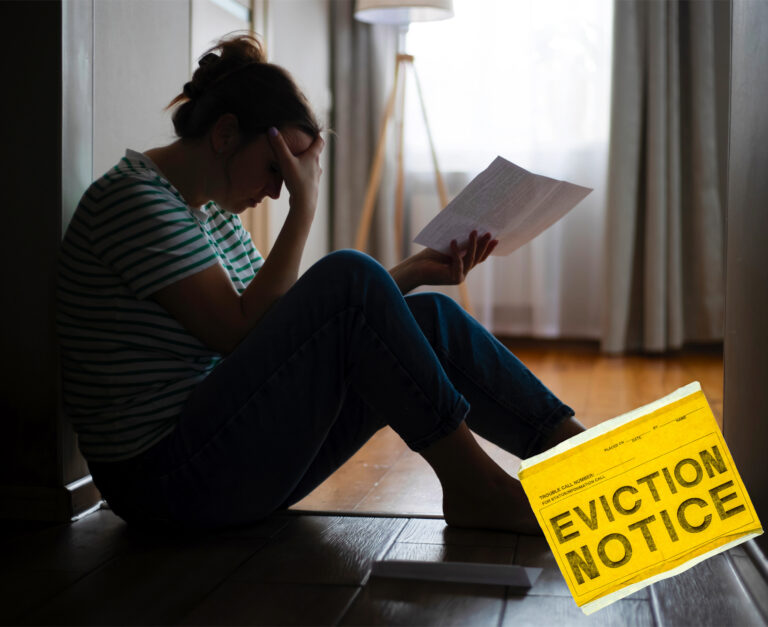 Tenant on floor in despair looking at an eviction notice