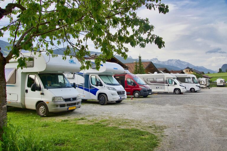 a row of mobile motor homes parked in a car park