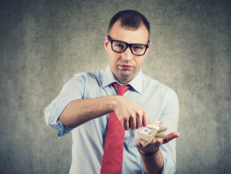 Businessman counting cash money in his hands.