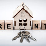 wooden house with rent words and keys and a pound sign