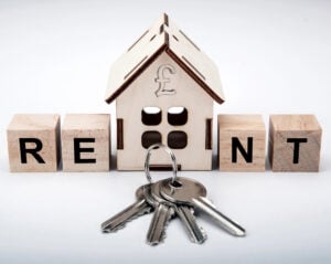 wooden house with rent words and keys and a pound sign