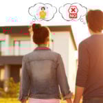 Couple looking at a modern house while reconsidering homeownership due to high costs