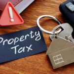 House key with property tax note and calculator symbolizing potential UK property tax changes