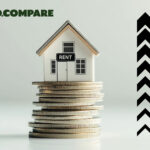 House model on stacked coins with rising rent arrows