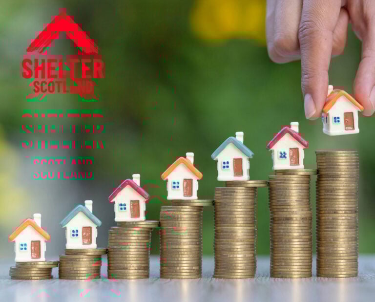 Miniature houses on stacked coins symbolising rising housing costs and social housing investment.